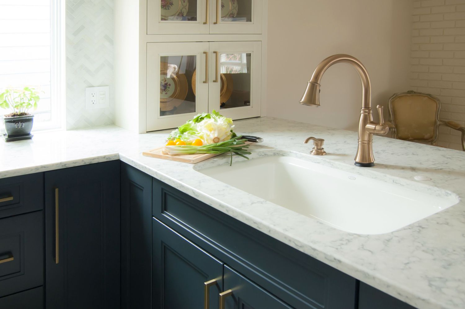 Haussys  Rococo quartz tops with Delta Cassidy faucet and Kohler Bakersfield Sink