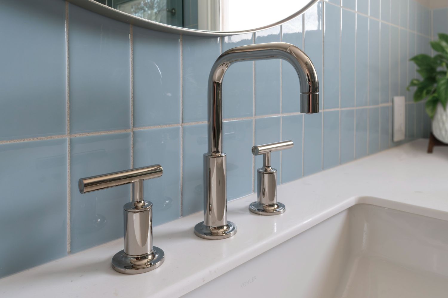 Kohler purist lavatory faucet with fireclay Egyptian Blue wall tile in primary bath