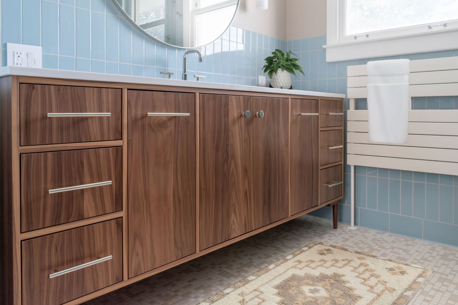 Primary bath walnut vanity with furniture legs. fireclay Egyptian blue wall tile in primary bath