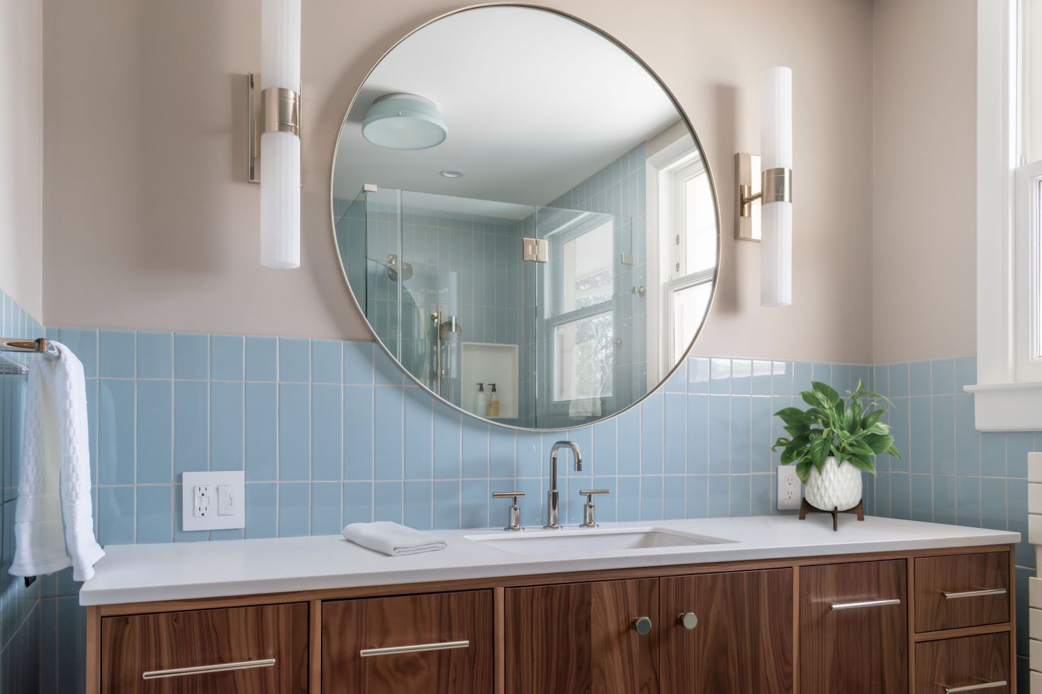 Primary bath walnut vanity with Fireclay epytian blue wall tile round mirror rejuvenation rigdon wall sconces