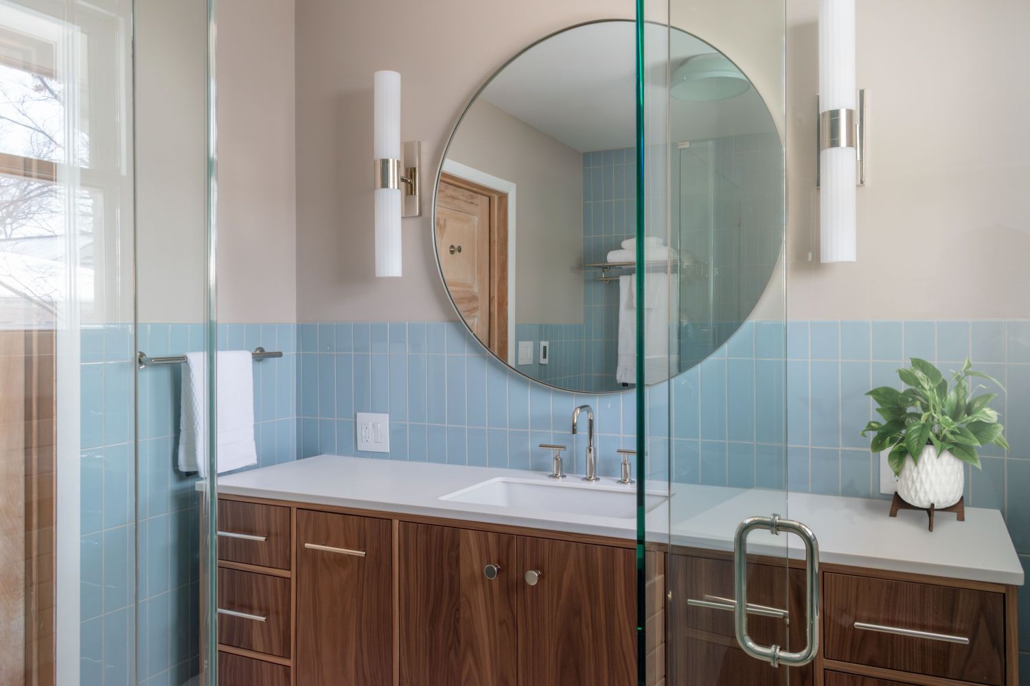 Primary bath walnut vanity with Fireclay epytian blue wall tile round mirror rejuvenation rigdon wall sconces