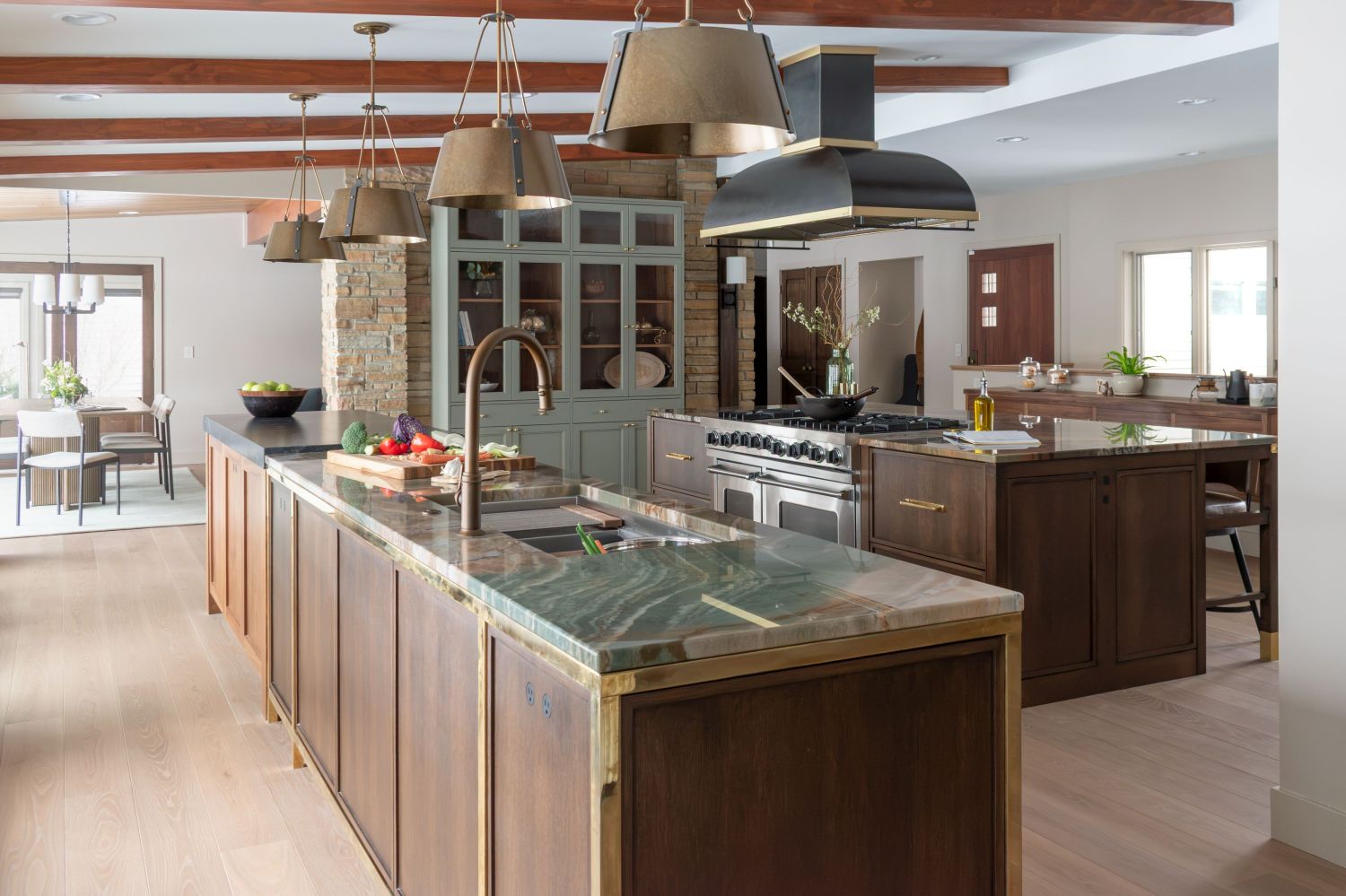 kitchen island with botanic quartz countertops plato woodworks cabinetry custom solid brass detailing Carlisle wood flooring in updated midcentury kitchen