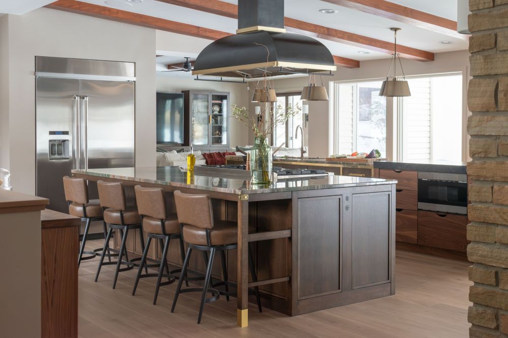 kitchen island with rangecraft hood plato cabinetry and Carlisle wood flooring