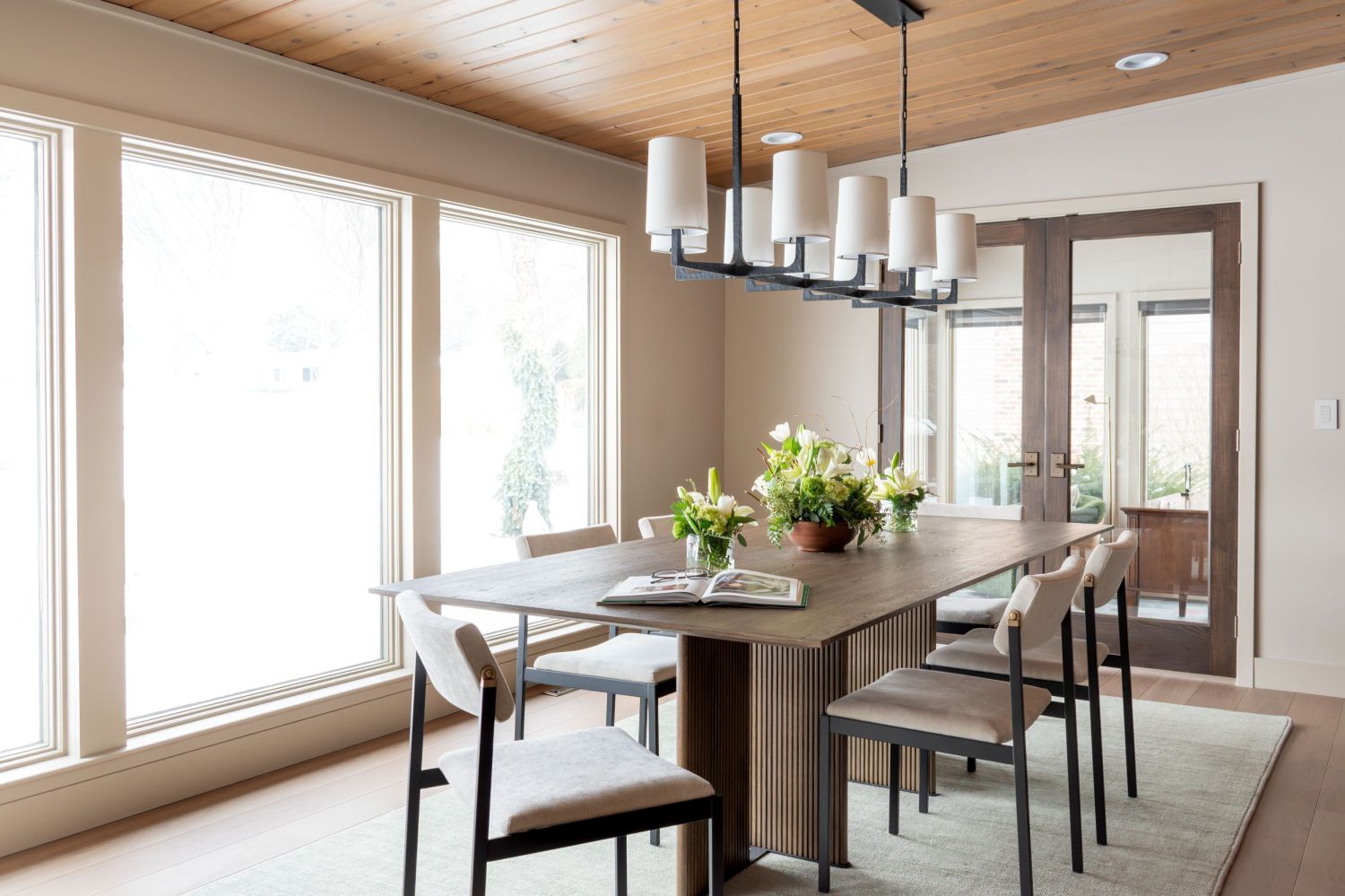 Four hands dining table in midcentury home Carlisle wood floors