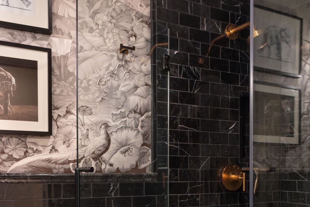 Guest Bath with shower black marble wall tile and herringbone floor