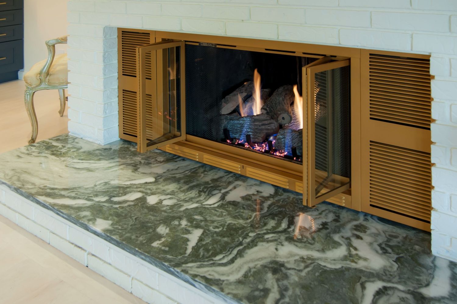fireplace refresh with Bianca Giada hearth and gold fireplace door
