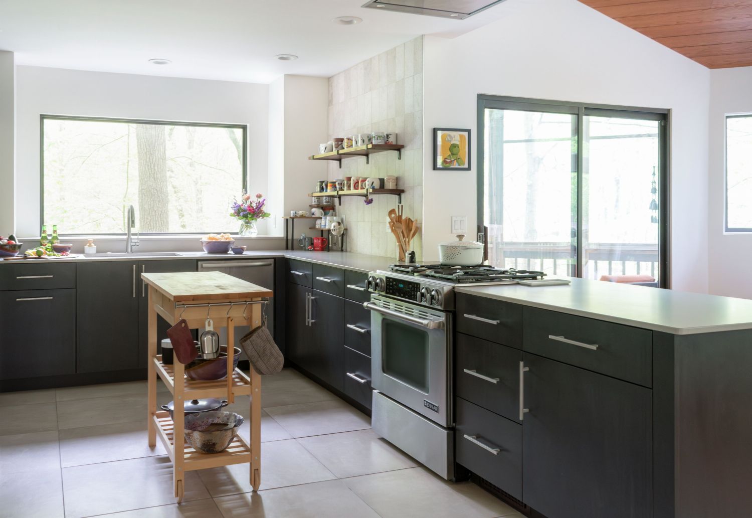 Eclipse maple cabinets with slide in range and open shelving large windows and open to family room