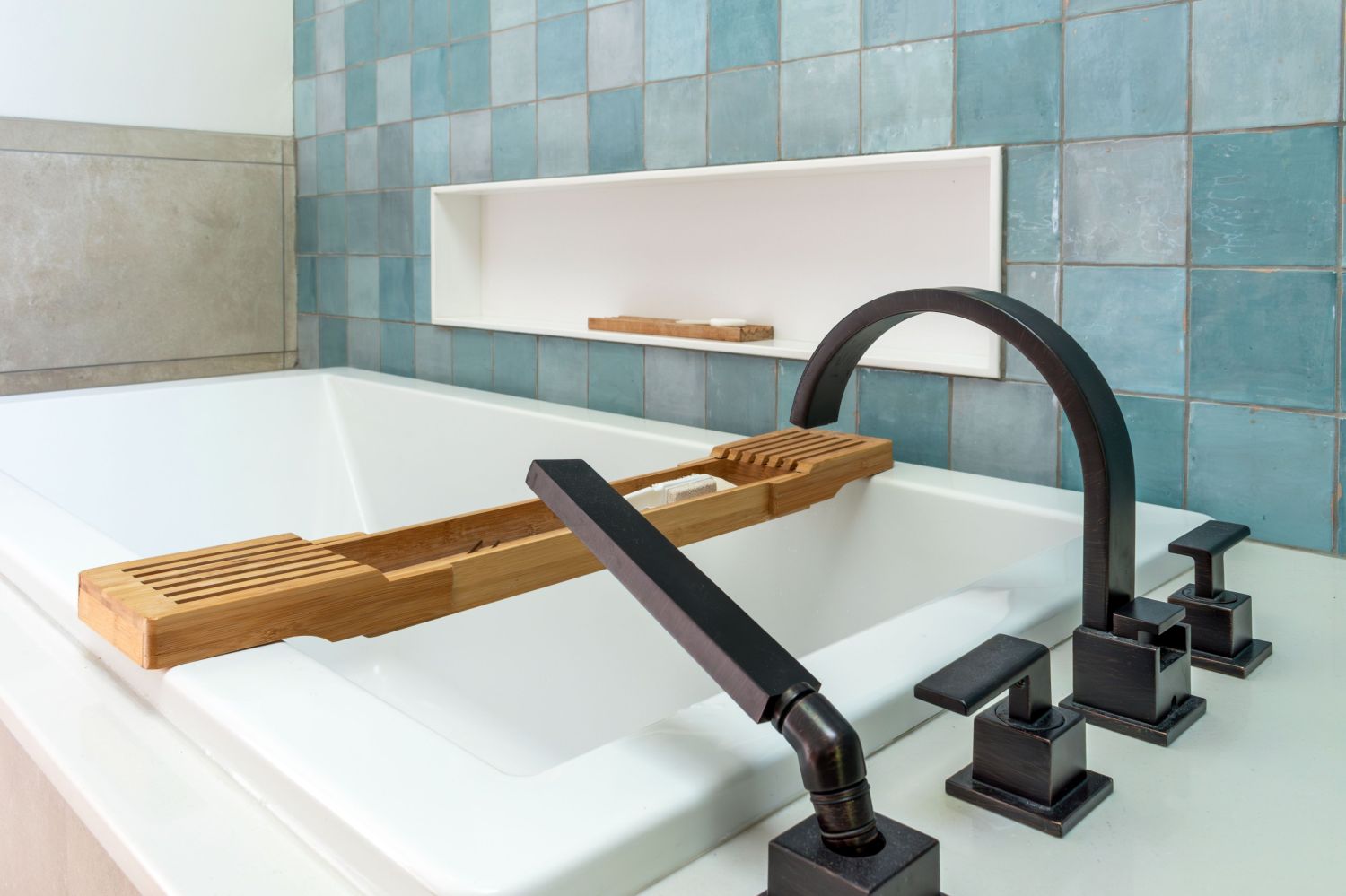 garden tub deck with corian wall niche and zellige wall tile