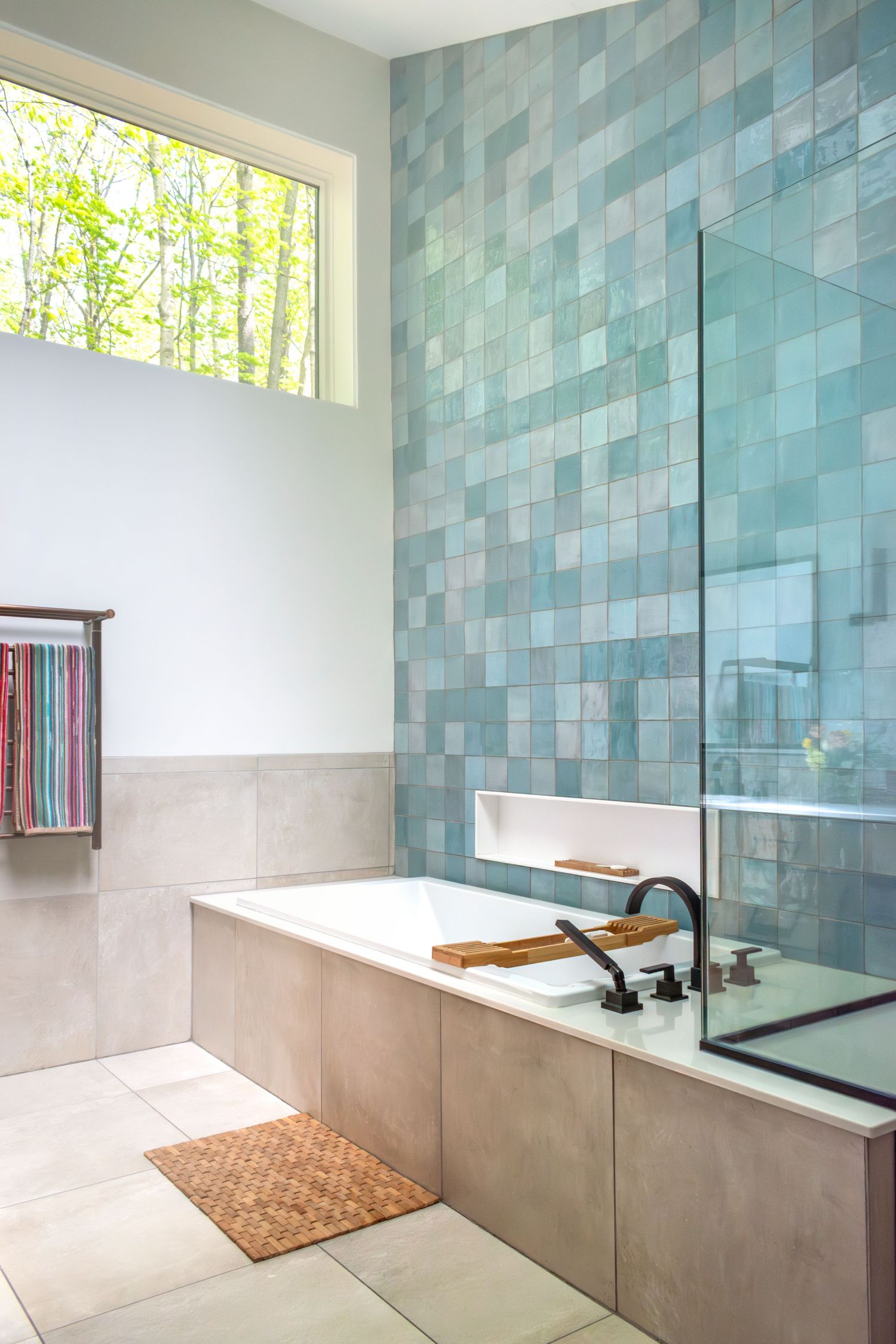 wow Zellige tile blue  above garden tub with quartz deck