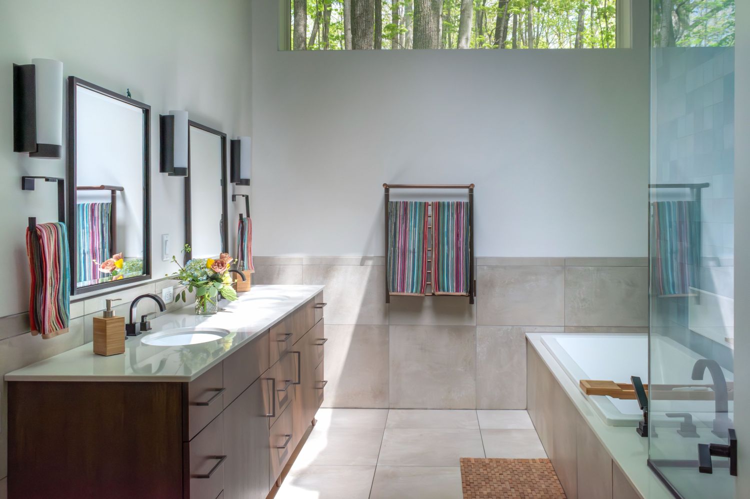 primary bath with maple vanity and large format tile oil rubbed bronze fixtures