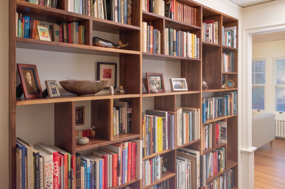 custom walnut bookcase in apartment entry