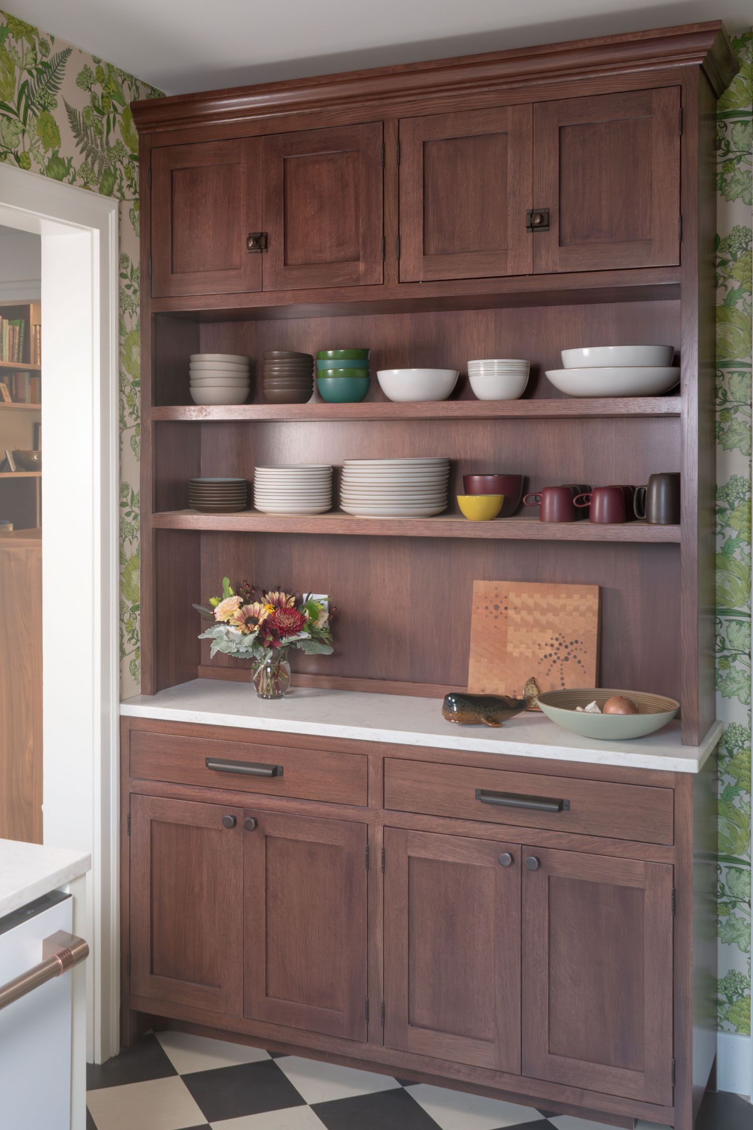 custom kitchen hutch with cork lined shelving and marmoleum flooring in classic coop apartment