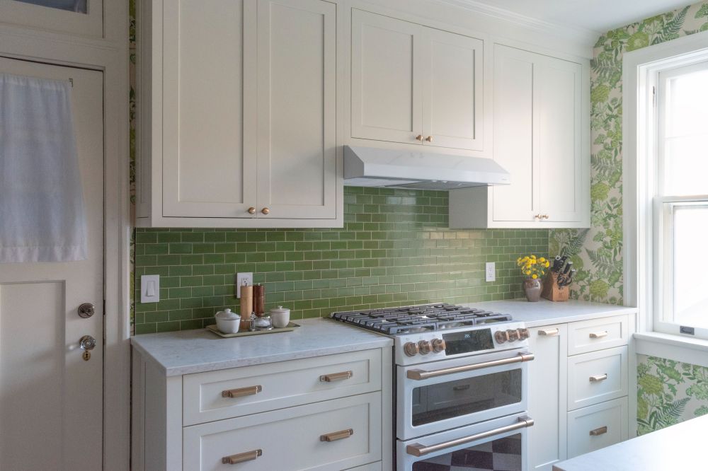Shiloh and eclipse painted cabinetry with spoonflower wallpaper and Heath Verde backsplash tile in historic coop apartment