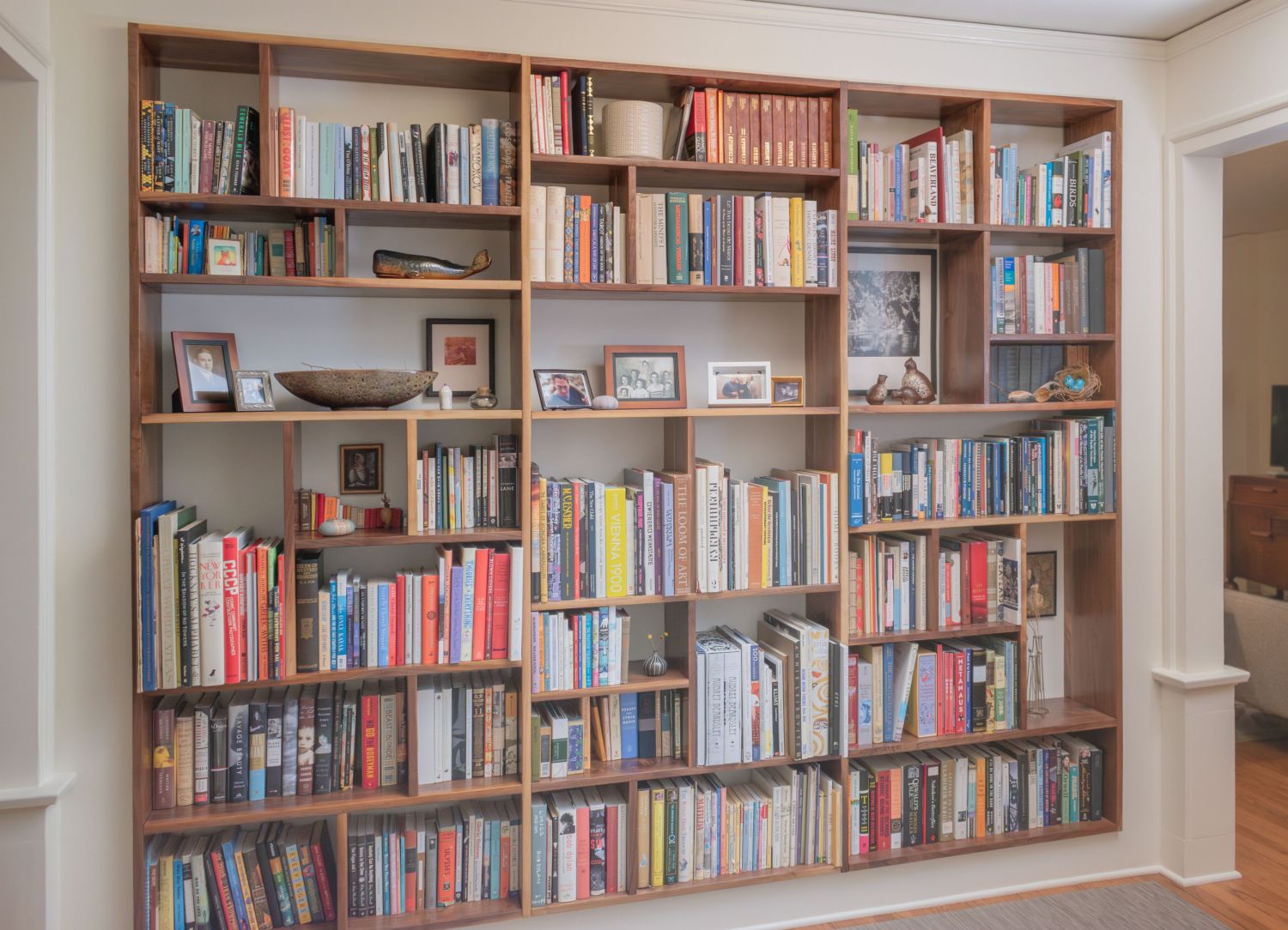 custom built walnut bookcase in apartment entry