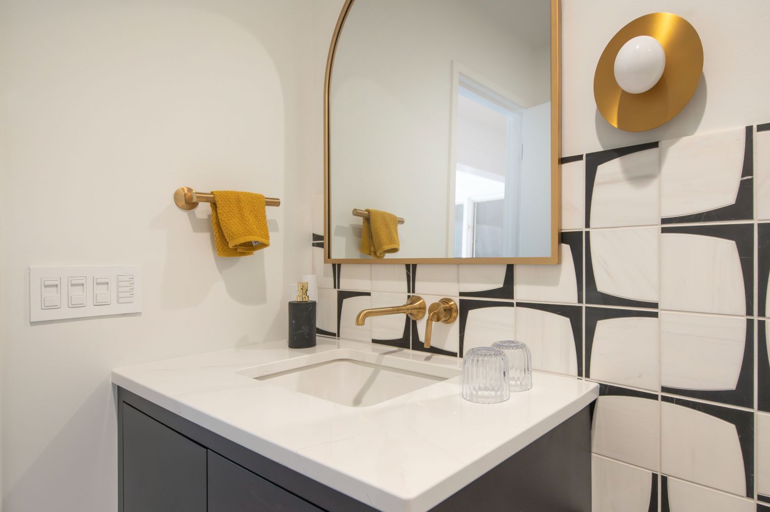 floating vanity in guest bathroom arched mirror and Nodes wall sconce