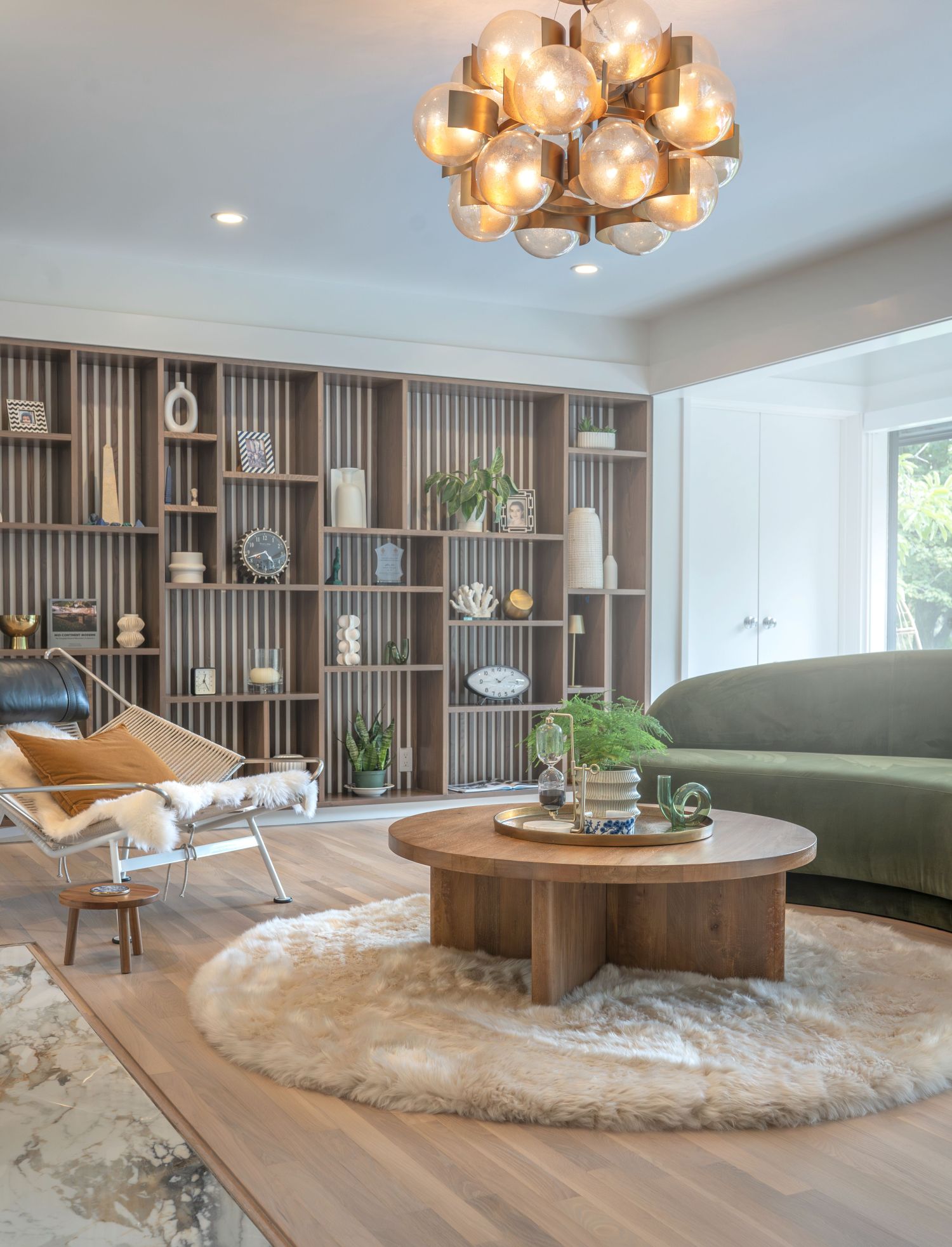 custom site built book case in bright living room with ceiling light