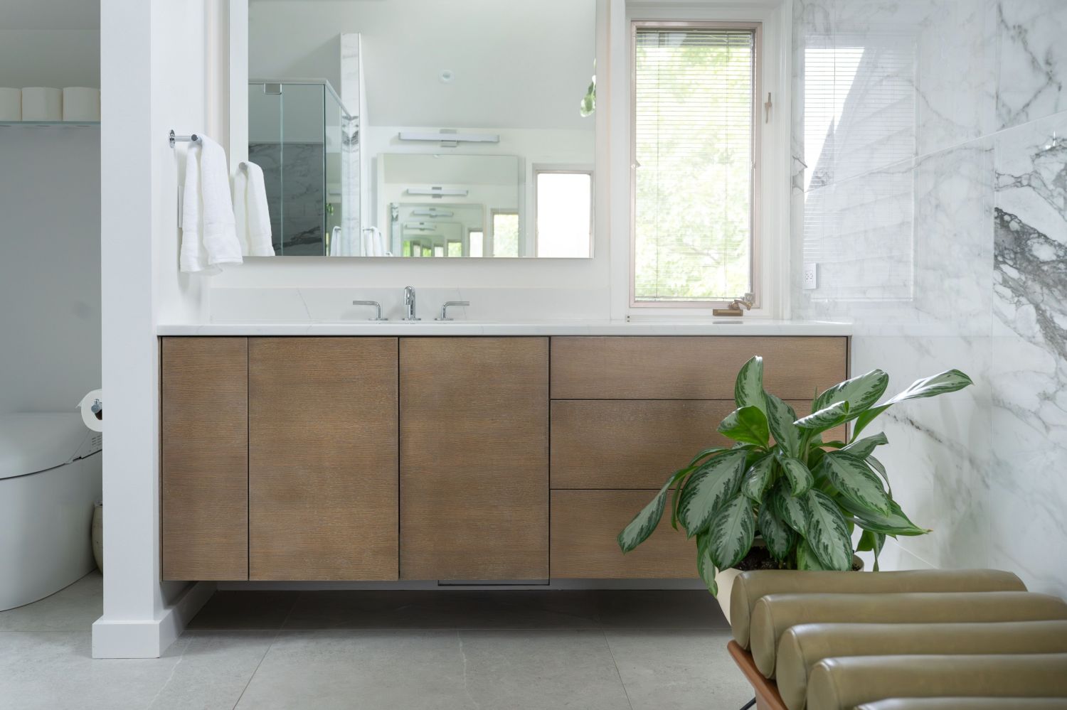 maple vanity with Seura mirror and natural light in primary bathroom