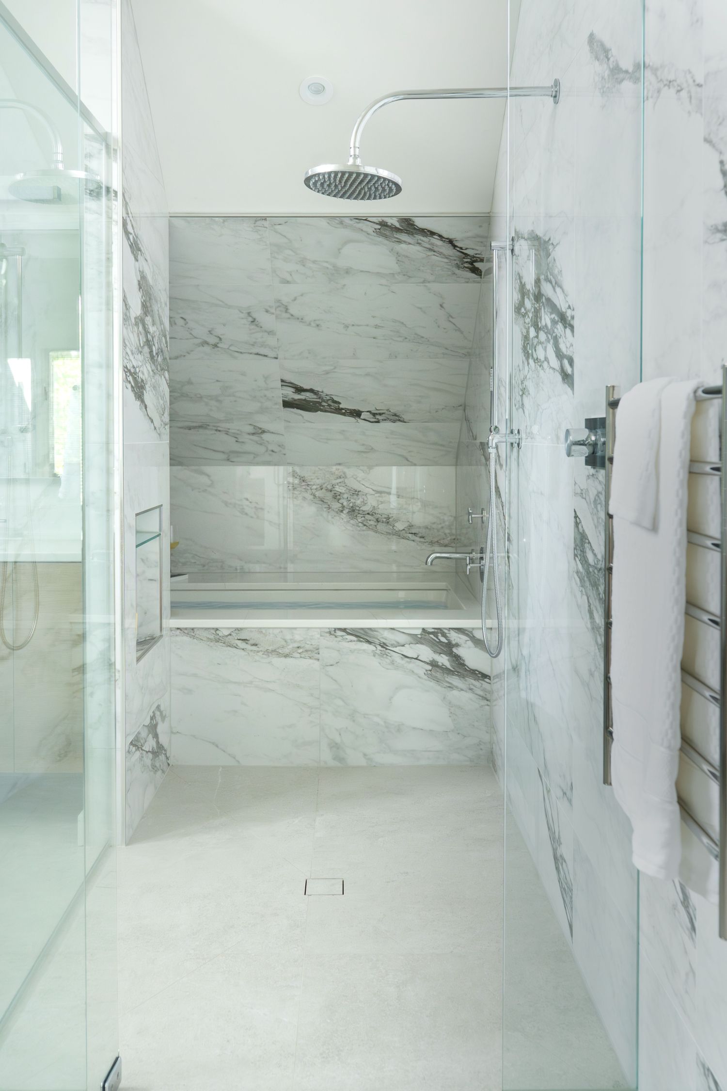 primary bath with barrier free shower and soaking tub with waterworks fixtures and imola tile