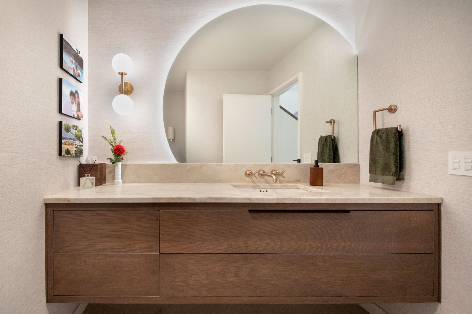 long floating vanity  with round backlit mirror in powder room