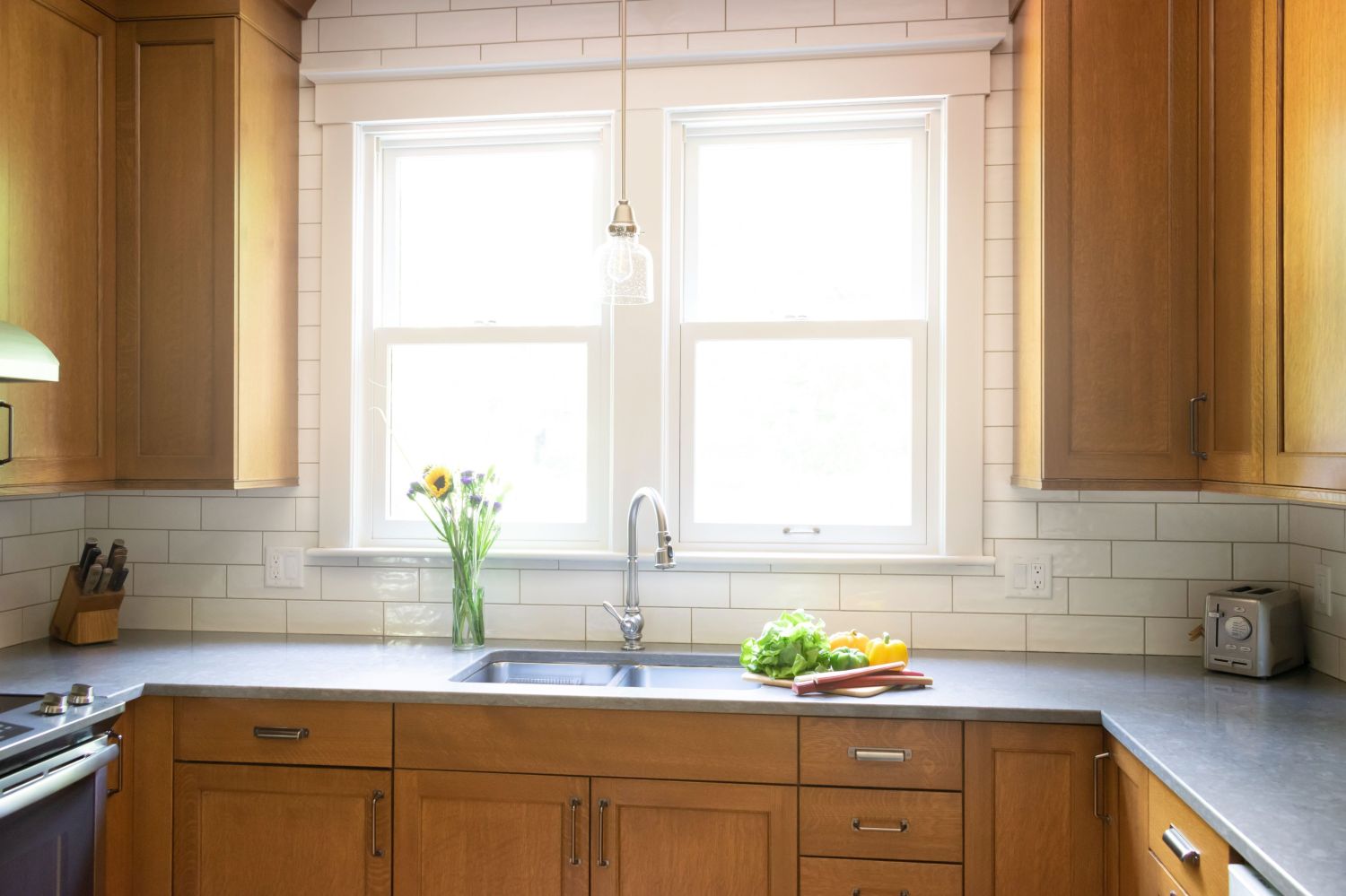 sink wall in kitchen with craftsman style quarter sawn white oak cabinetry