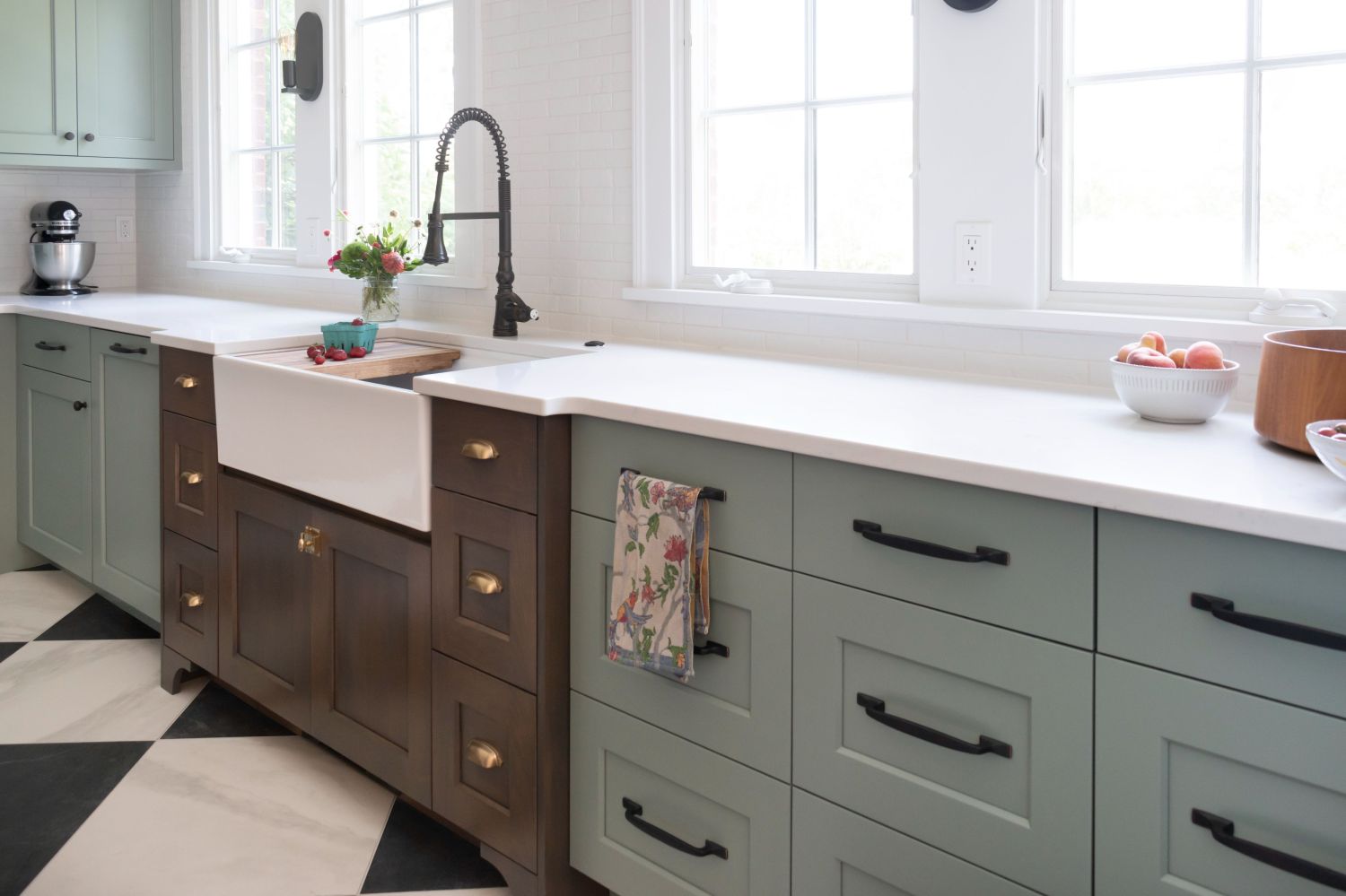 kitchen with painted and stained cabinetry with natural light in historic home