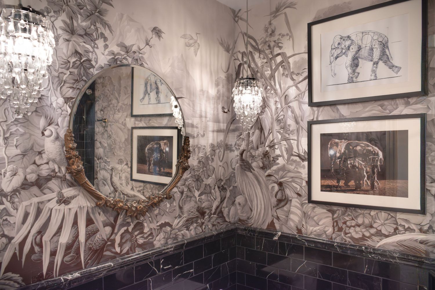 African mural panels in bathroom with round mirror and black marble tile