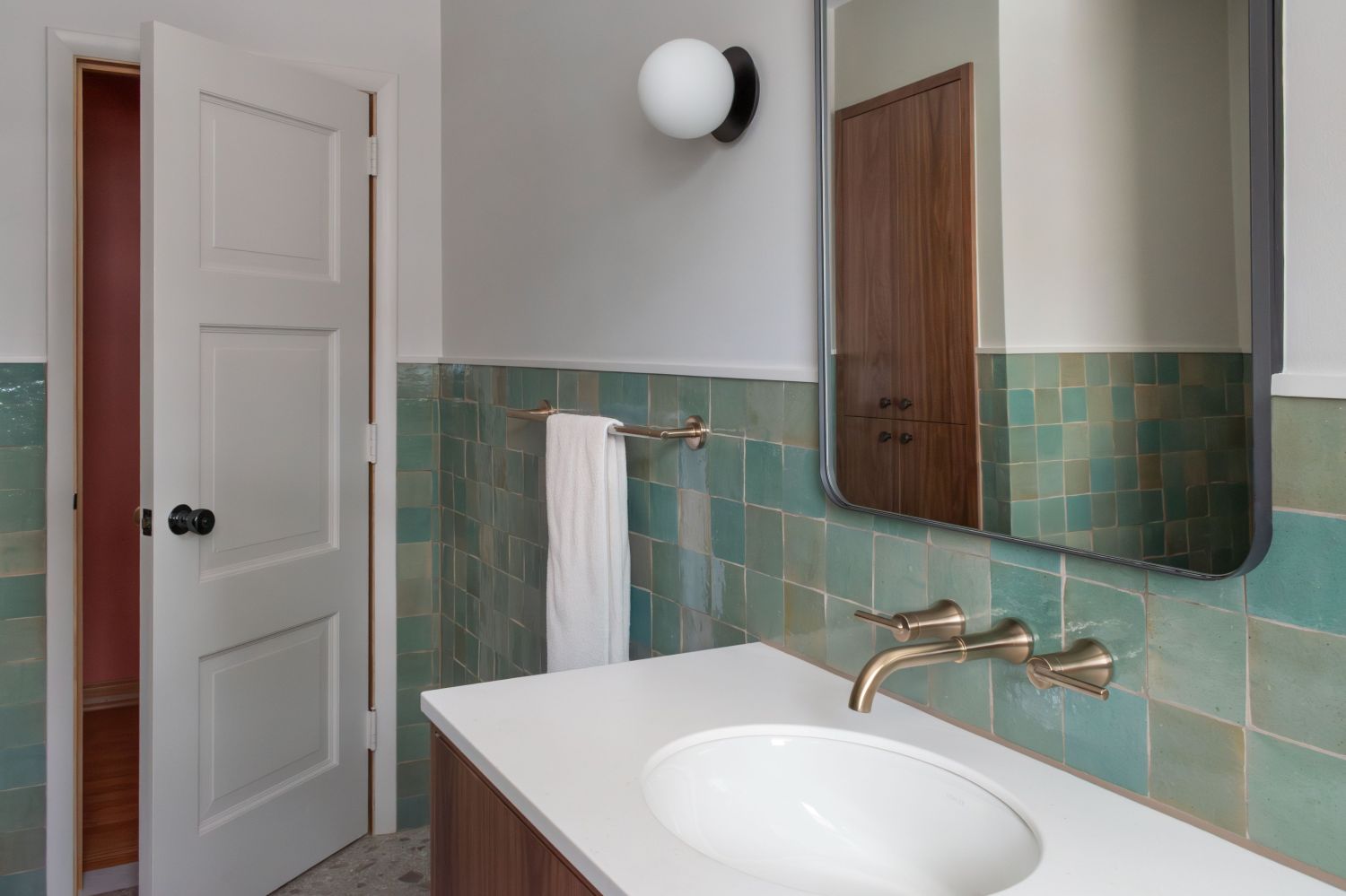 Lili Agave Green Zellige Tile with Delta trinsic Wall mount faucet in Champagne Bronze. corian vanity top in bathroom